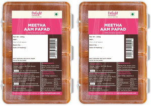 Two packages of Meetha Aam Papad with labels showing product details.