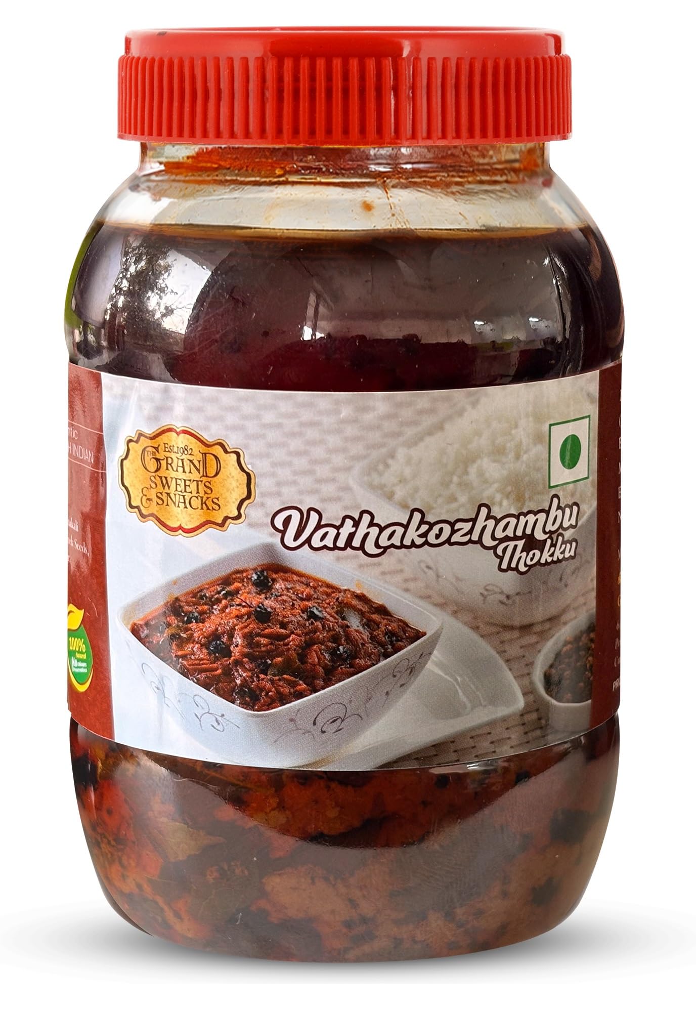Jar of Vaihakozhambu Thokku with a red lid on a white background