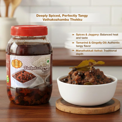 Jar of Vathakozhambu Thokku with a bowl of the dish on a wooden surface.