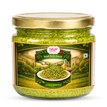 Jar of basil pesto sauce with a gold lid on a white background