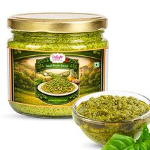 Jar of Delight Foods Basil Pesto Sauce with a bowl of pesto on a white background