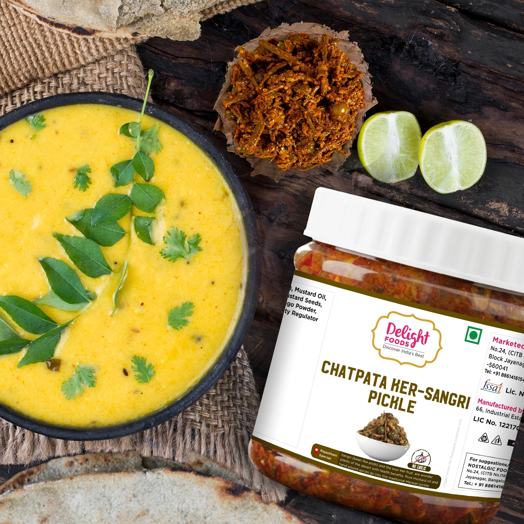 Jar of Chatpata ker Sangri Pickle with a bowl of yellow soup and ingredients on a wooden surface