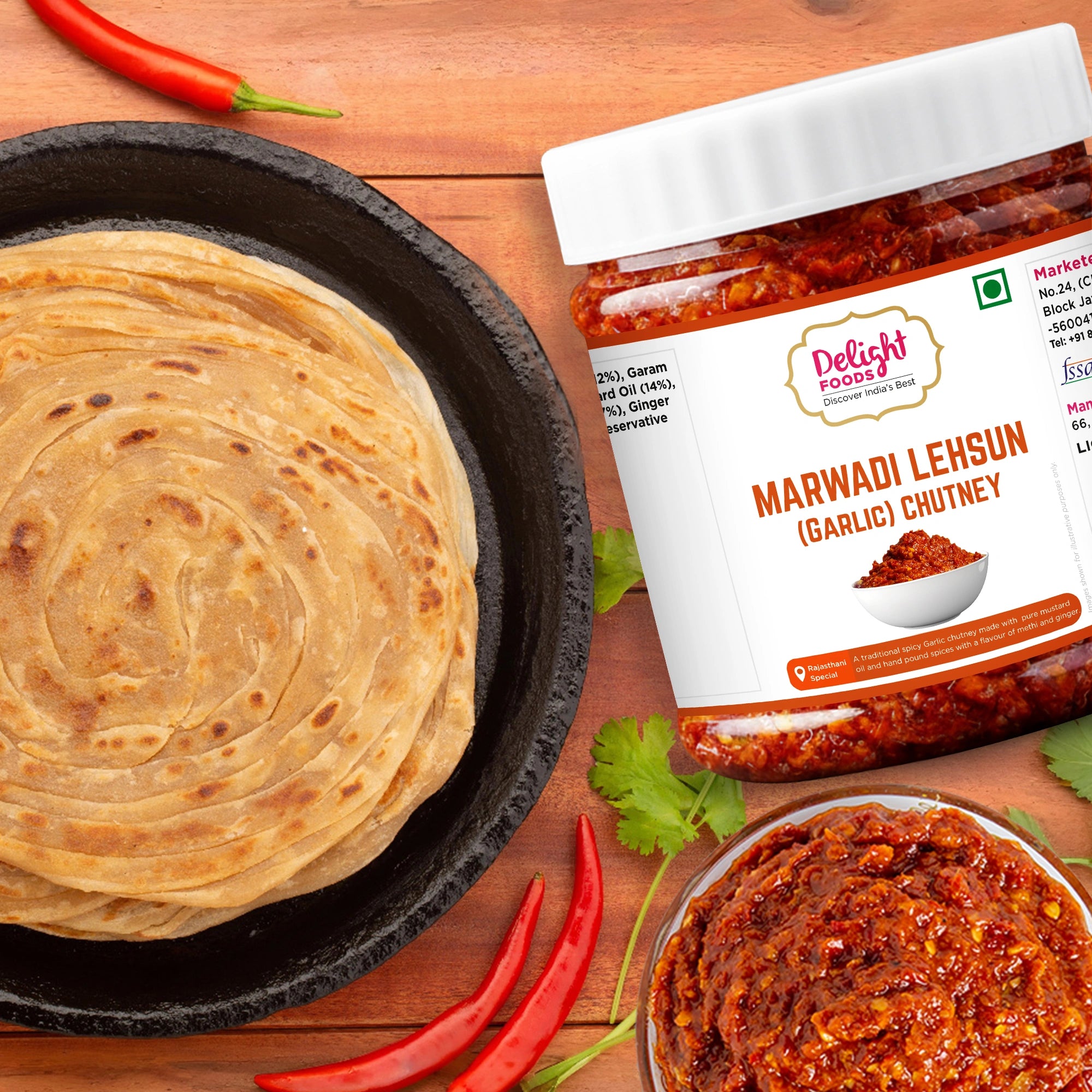 Jar of Delight Foods Marwadi Leh sun chutney with roti and chutney on a wooden surface