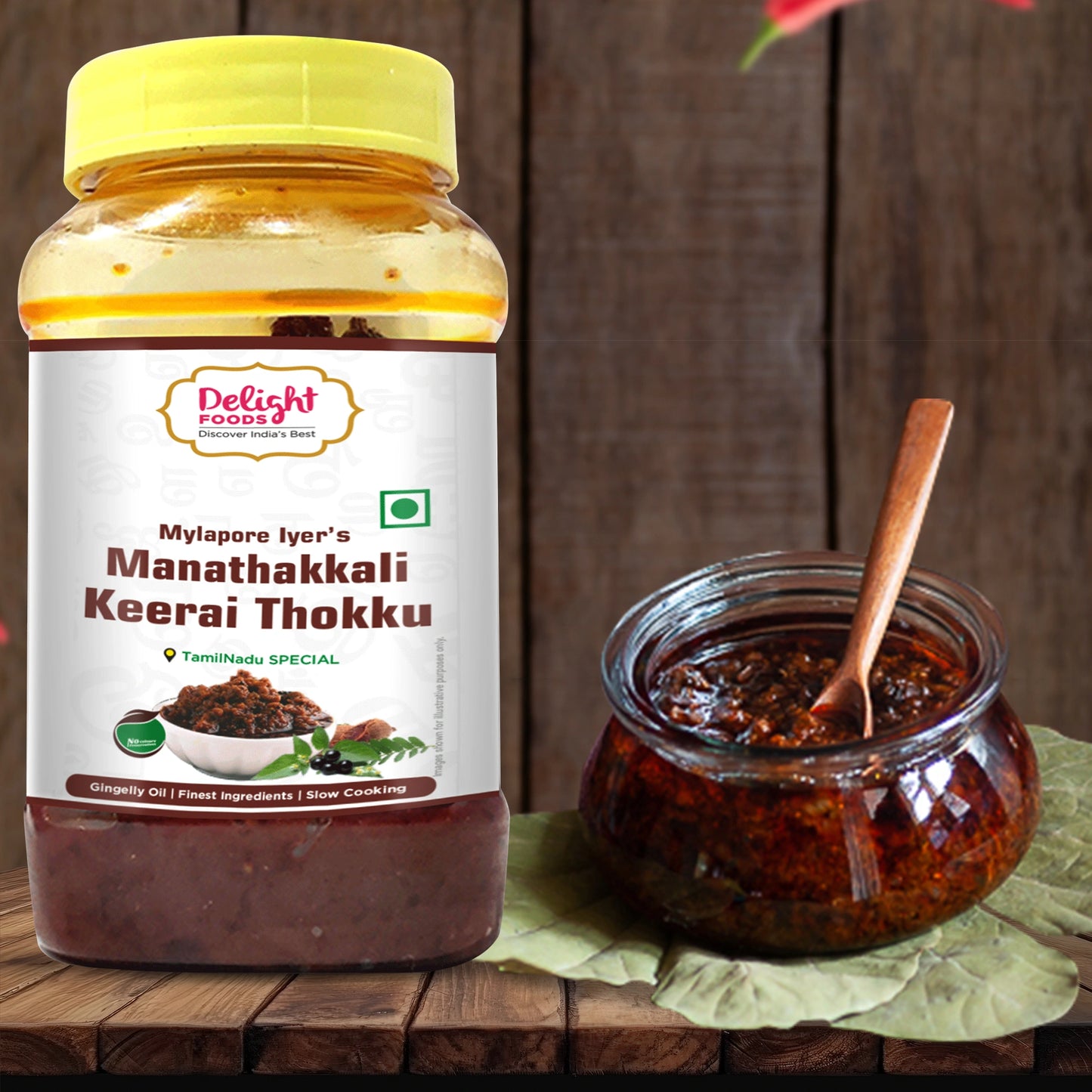 Jar of Manathakkali Keerai Thokku with a spoon on a wooden surface