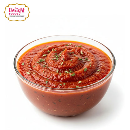 Bowl of red sauce with herbs on a white background, featuring Delight Foods logo.